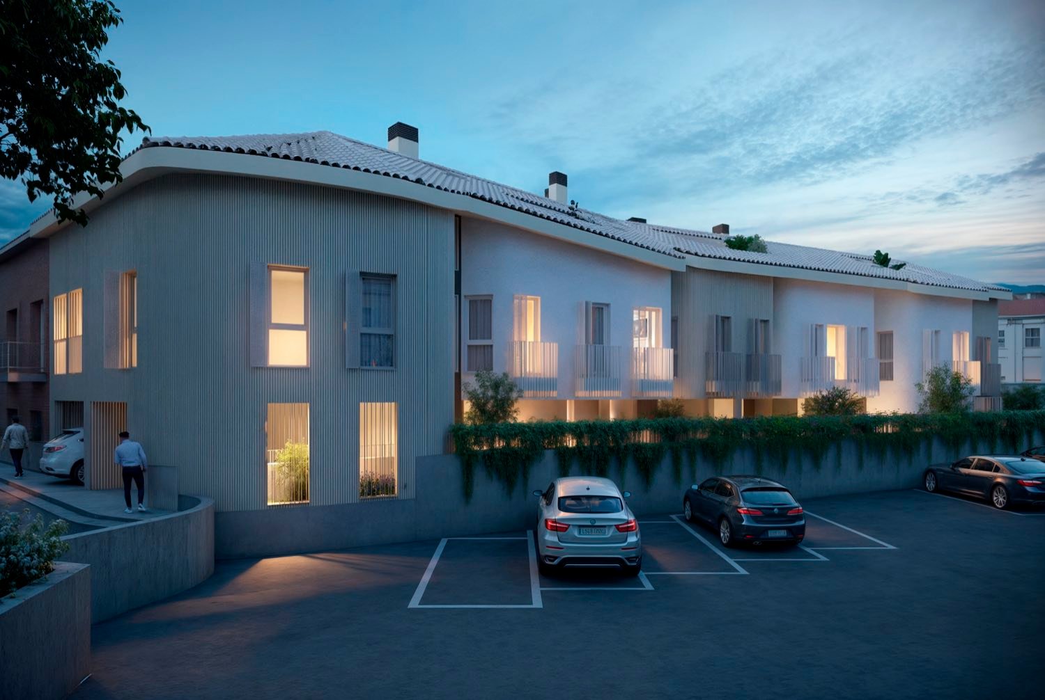 Render del Residencial Guayanas al anochecer, visto desde la esquina, con las ventanas iluminadas.